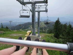 We are riding the chair lift back down from the Peak of Grouse Mountain