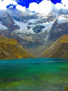 Lake Humantay on Salkantay Hike with clear water and snowy mountains