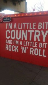 A sign at the Calgary Stampede saying 'I'm a Little Country and I'm a little bit rock 'n' roll'