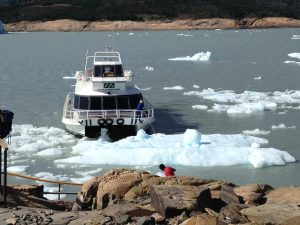 The boat trying to dock on Lake Argentino with large icebergs in the way