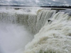 Water rushing over the devils throat of Iguazu Falls