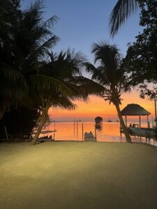 A bright orange and pink sunset over the sea in Caye Caulker in Belize
