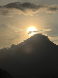 yellow circular sun over the shadow of Volcan Conception during 2-week adventure backpacking Nicaragua
